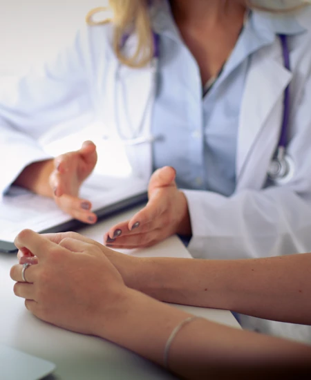 Doctor sitting with patient discussing healthcare options