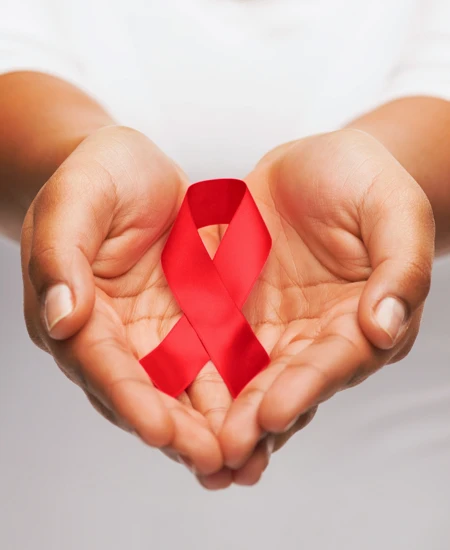 Hands holding a red ribbon